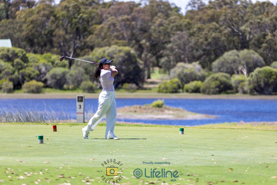 Female golfer in centre of frame