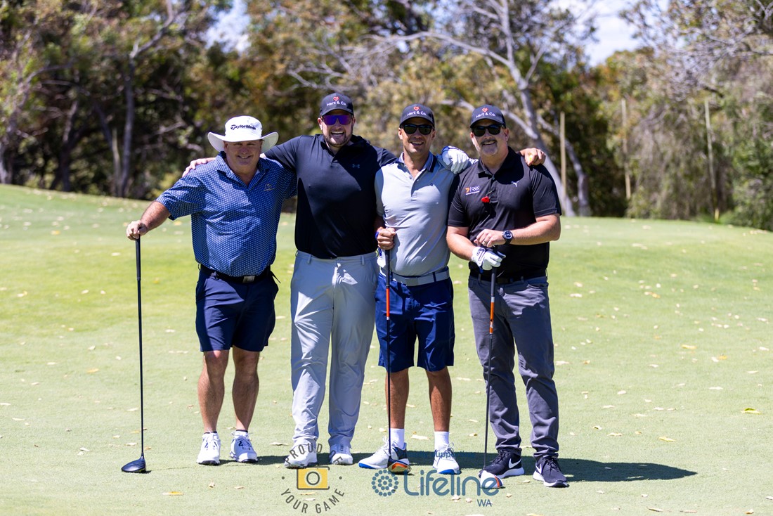 A team of 4 golfers posing together on a golf  course